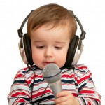Given a speech toddler with headphones and microphone, closeup